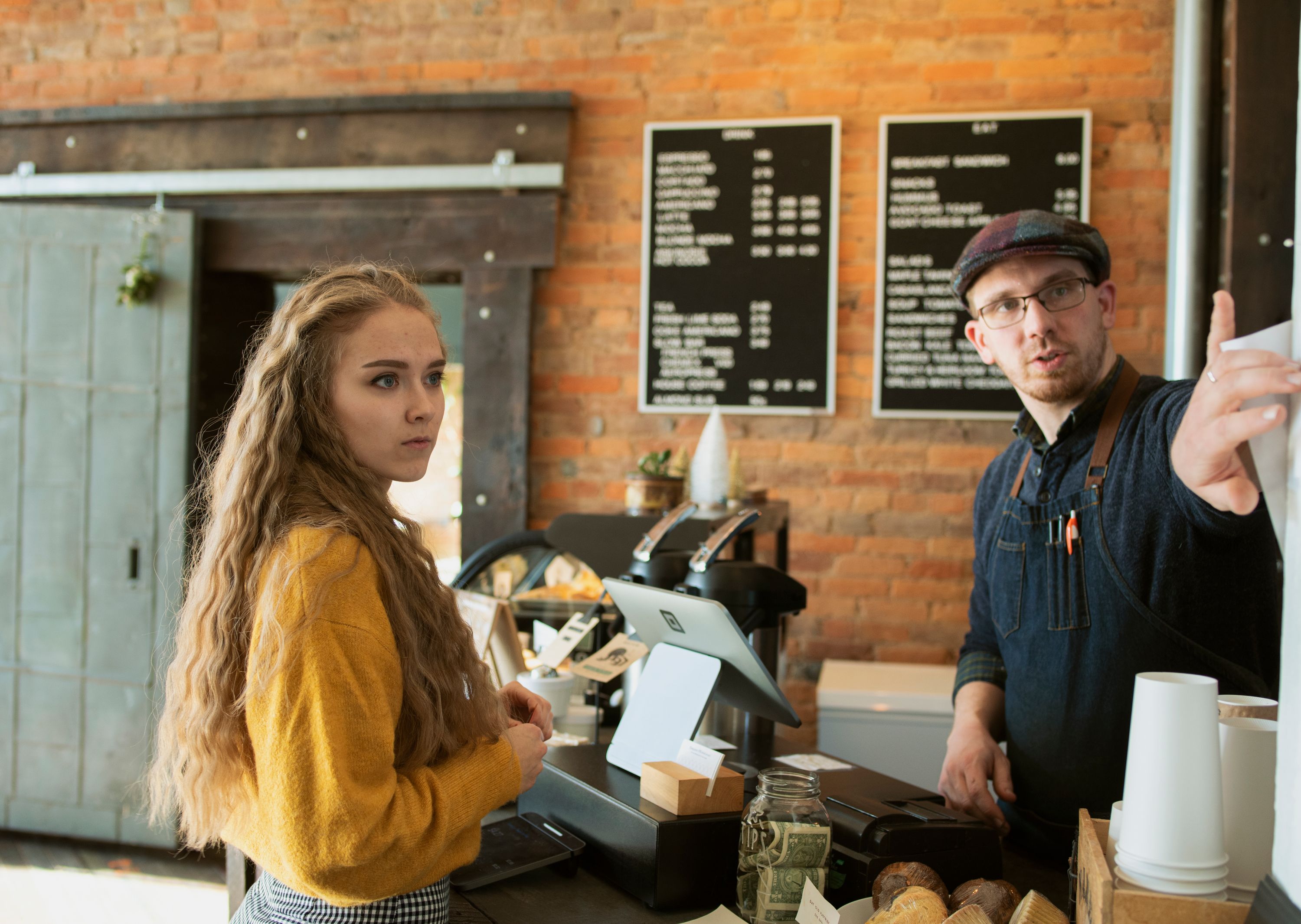 Two people talking quietly and candidly across a counter
